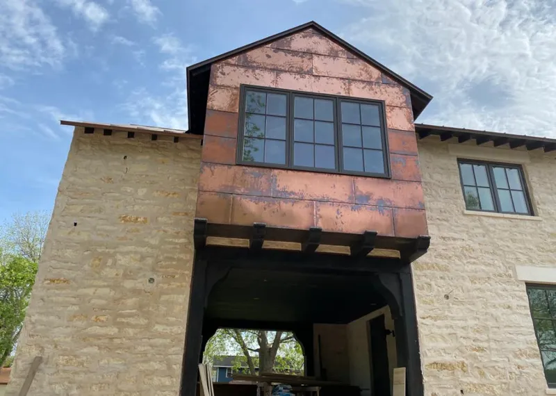 Copper metal panel facade on a stone building for Skylight Installation in Grayson